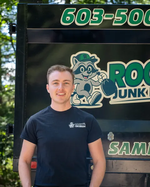 Andrew from Rocky's Junk Removal in front of the Rocky's dump truck