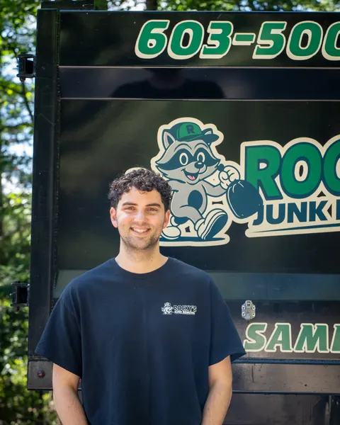Jacob from Rocky's Junk Removal in front of the Rocky's dump truck
