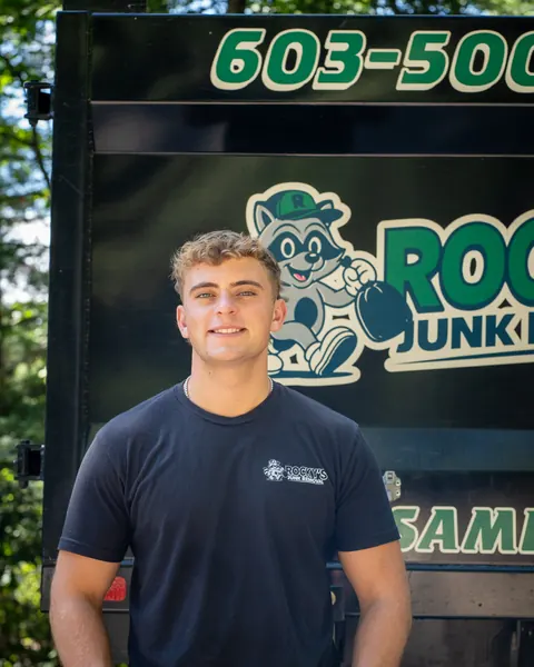 Mathew from Rocky's Junk Removal in front of the Rocky's dump truck